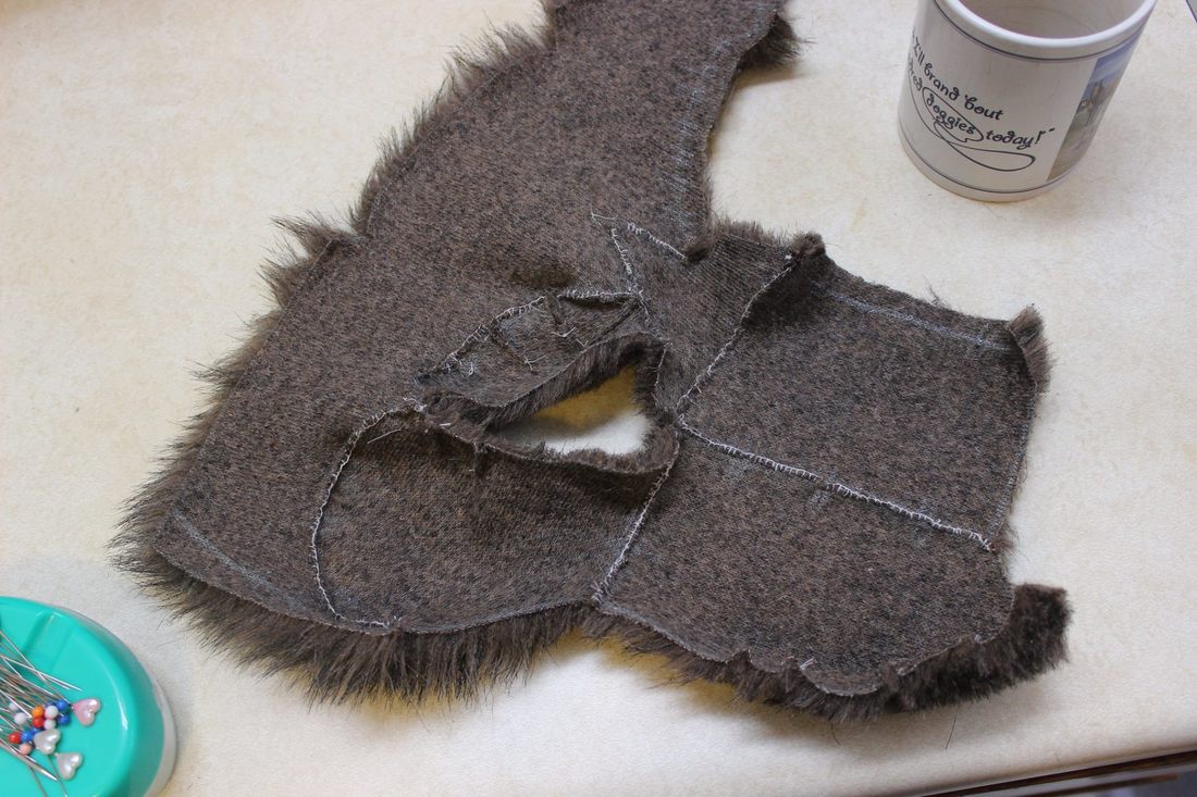 fur pieces for half the mask face hand sewn together with blanket stitch
