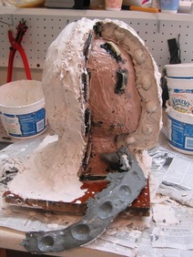 clay dividing wall removed from the plaster mother mold
