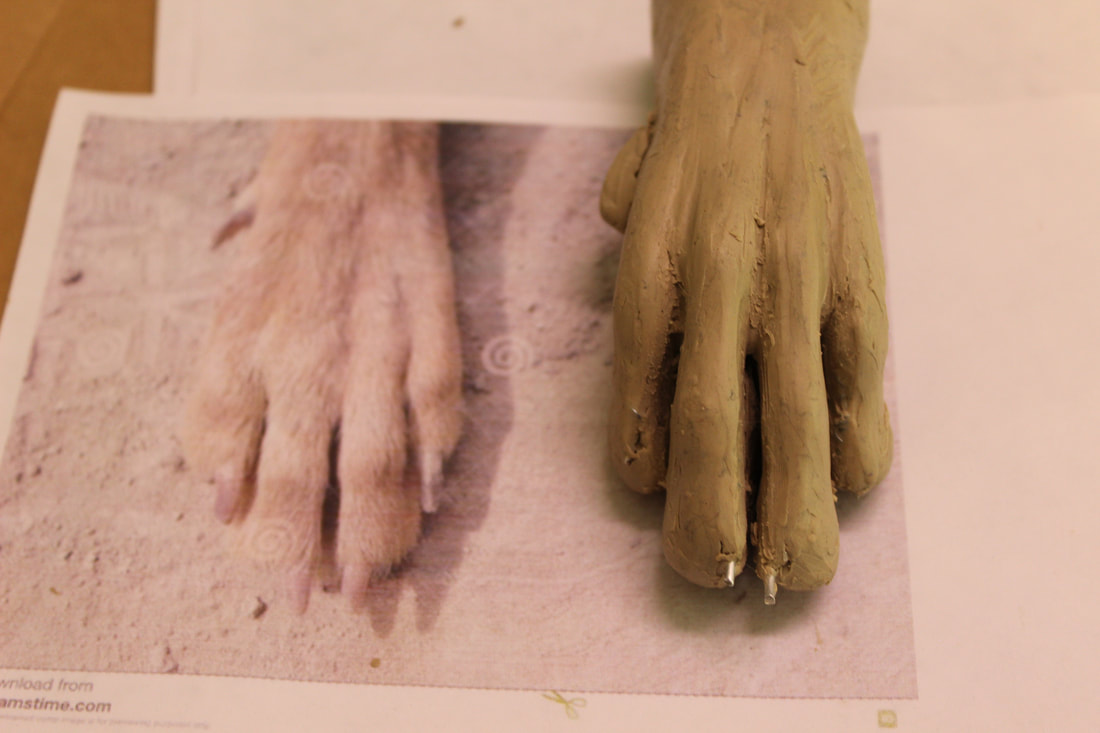 clay model for a fursuit handpaw